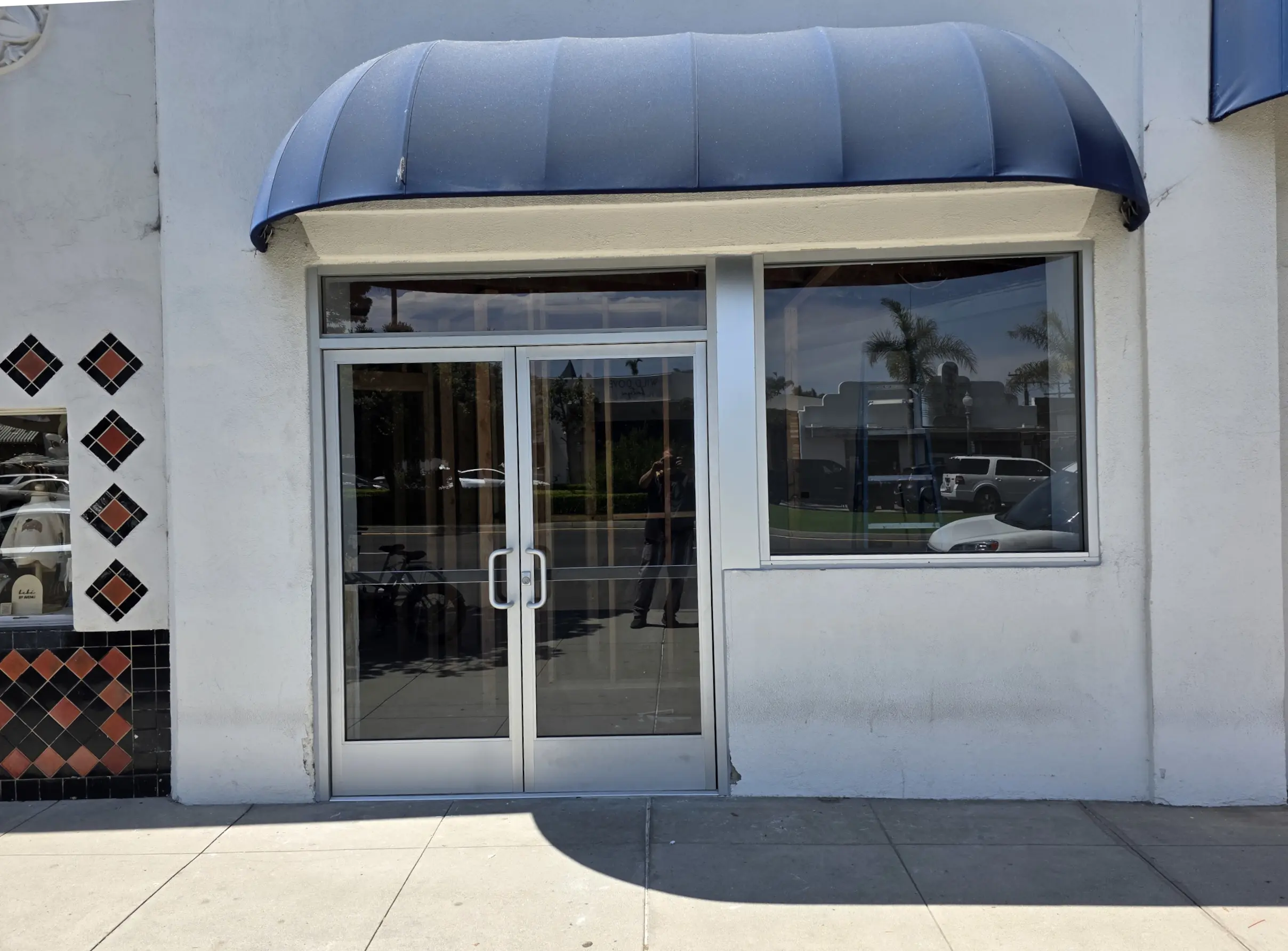 Modern commercial storefront door installation with aluminum frame and glass